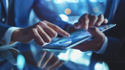 two-businessmen-suits-are-using-tablet-computer-analyze-graphs-charts-tablet-is-sitting-glass-table-reflecting-image